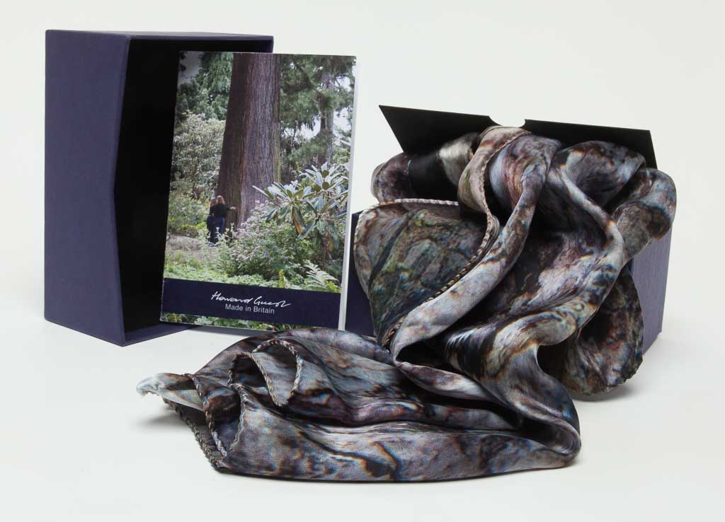 The 100% silk Black Pine Scarf with the box and pamphlet. Designed by Howard Guest and Made in Britain.